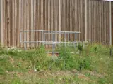 safety barrier made out of Interclamp steel handrails in front of wooden fence 