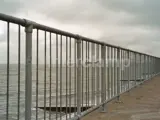 Handrail barrier in front of ocean and sea defence system. Creating a safety barrier for pedestrians walking along the beach front